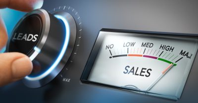 Hand turning a knob to set number of leads to the maximum to generate more sales. Composite image between a photography and a 3D background. Horizontal orientation.